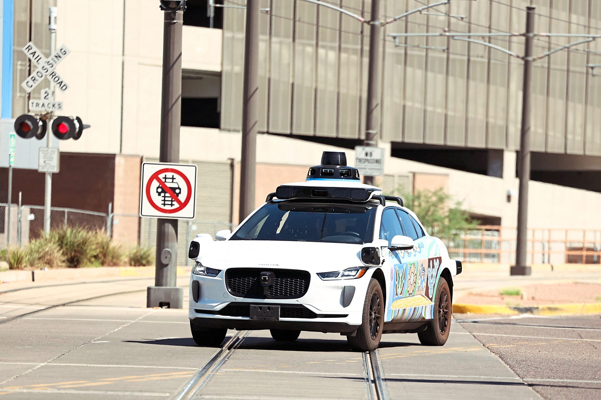 Waymo Train Passenger Leaps Out of a Waymo After Self-Driving Car Stopped on Train ...